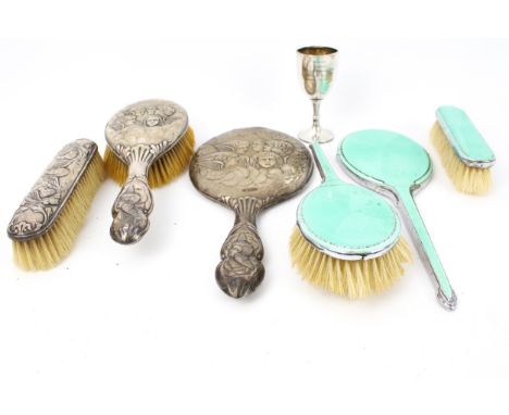 A collection of silver including a silver mounted three piece dresssing table set. The oval hand mirror, oval hair brush and 