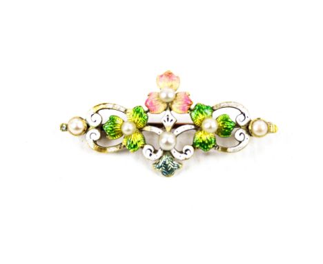 A late Victorian gold, polychrome enamel and seed-pearl open work floral brooch. Designed as pink and green leaf trefoils wit