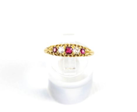 An early 20th century gold, ruby and diamond five-stone ring. The three graduated small round mixed-cut rubies spaced by smal