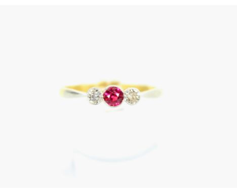 An early 20th century gold, synthetic-ruby and diamond three-stone ring. Centred with a round mixed-cut ruby between small ol