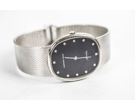 Audemars Piguet, a gentleman's Swiss 18ct white gold oblong bracelet watch circa 1975(?). The black oblong dial with diamond 