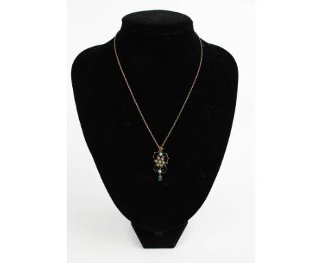 An Edwardian gold, turquoise and half-pearl pendant and chain. The openwork pendant centred with a turquoise and half-pearl f