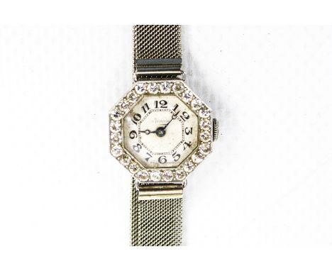 A lady's Art Deco Swiss platinum and diamond octagonal bracelet watch, No.12677. The silvered dial with black Arabic numerals