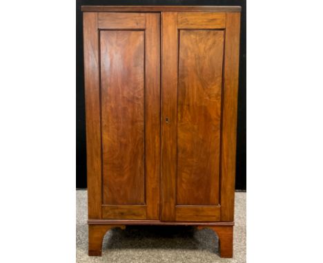 A Victorian mahogany hall cupboard, pair of doors enclosing three tiers of shelving, bracket feet, 103cm high x 61.5cm wide x