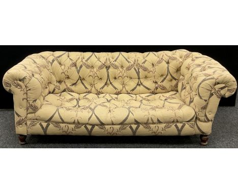 A Chesterfield sofa, deep button-back, fabric upholstery, turned legs, 65cm high x 182cm wide x 89cm deep. 