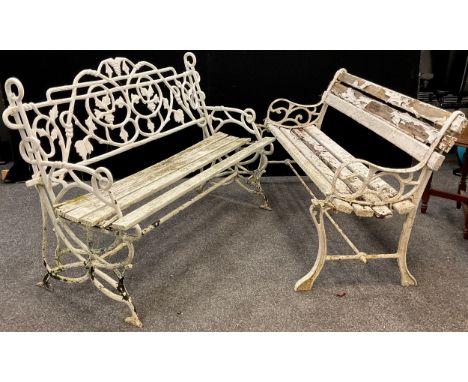 An early to mid 20th century cast iron garden bench, the back and sides cast as entwined fruiting vines, painted white, woode