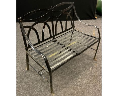 An early to mid 20th century iron strapwork garden bench, arched back, slat strap seat, painted black finish, 97cm high, 113c