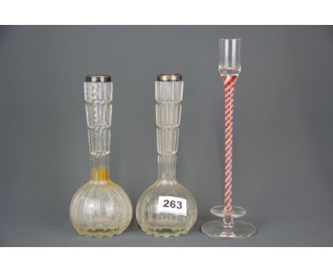 A pair of Victorian hallmarked silver topped glass vases together with a Latticinio glass candlestick, tallest 25cm.