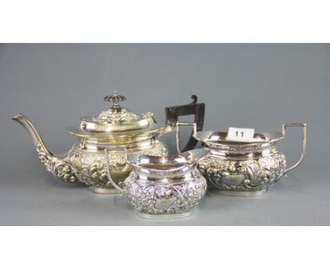 A relief decorated silver plated three piece tea set, teapot H. 15cm.