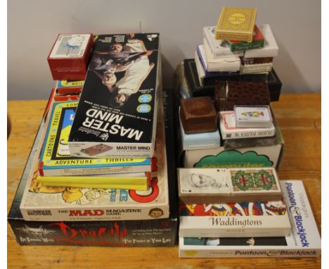 A quantity of mixed playing cards and games.