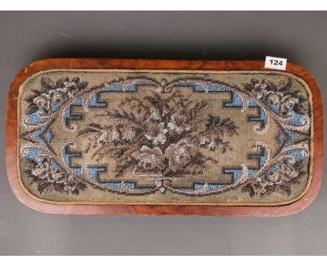 A 19th Century beadwork tapestry set in a walnut veneered tray frame resting on four feet, 59 x 29cm.