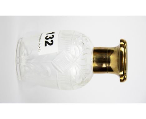 A 9ct gold topped cut glass perfume bottle with engine turned decoration.Gross weight - approx. 195gr.&nbsp;