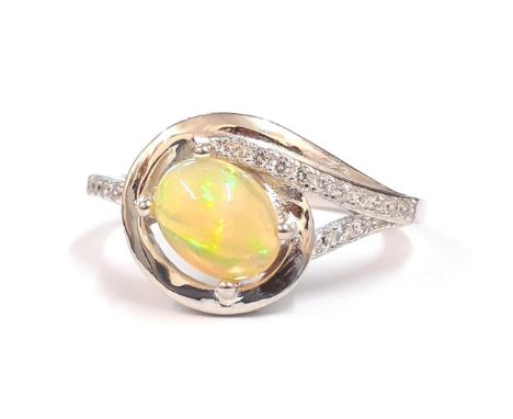 A 925 silver ring set with a cabochon cut opal and white stones, (P).