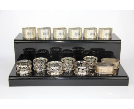 A set of six hallmarked silver engine turned napkin rings together with a further pair of hallmarked silver and six EPNS napk