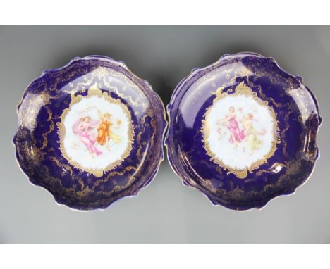 A pair of 19th Century Austrian gilt finished porcelain wall plates, Dia. 34cm.