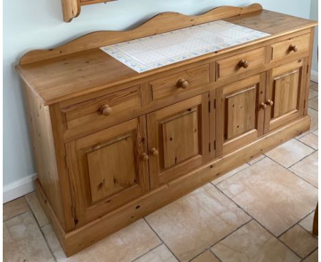 A pine kitchen cabinet with a tile inset top, W. 182cm. H. 82cm.