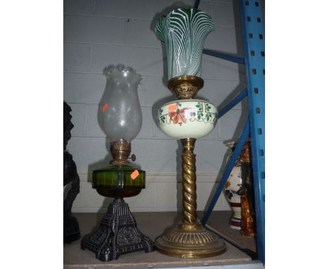 A VICTORIAN BRASS OIL LAMP, green and white striped shade, glass reservoir, rope twist column on circular base, height approx