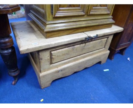 A LIGHT OAK COFFEE TABLE, the sliding top revealing storage area