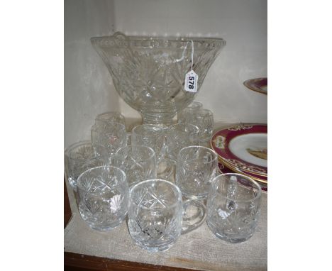 A CUT GLASS PUNCH BOWL, on pedestal foot, together with twelve glasses and a ladle