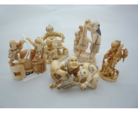 FIVE NETSUKE, depicting demons and men with children, largest measuring 6 x 3.5cm, all signed
