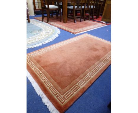 A TERRACOTTA GROUND CARPET, approximate size 240cm x 170cm and a matching smaller rug (2)