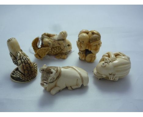 FIVE NETSUKE, to include entwined frogs, a man on a fish and a bull with two others, four signed