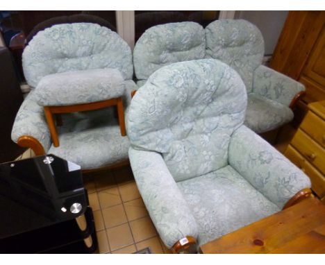 AN UPHOLSTERED FOUR PIECE SUITE, comprising of a two seater settee, a pair of armchairs and a pouffe