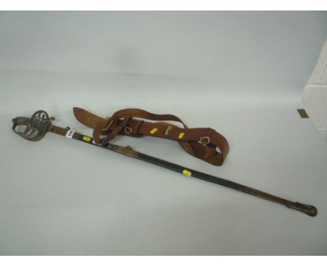 A VICTORIAN BRASS MOUNTED PRESENTATION SWORD AND SCABBARD, etched blade inscription to 'QM Serjt J.A. Smith' by the officers 