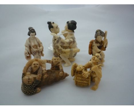 FIVE NETSUKE, to include a figure of lovers, a man with a frog, women etc, largest measuring 6 x 5cm, four signed