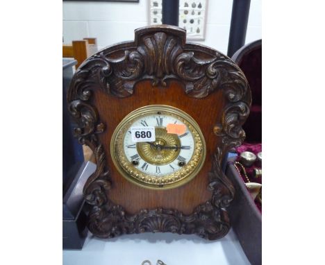 A CARVED OAK AMERICAN MANTLE CLOCK, manufactured by 'Ansonia Clock Co New York', height approximately 34cm (key and pendulum)