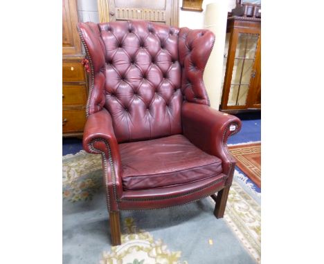 A RED LEATHER BUTTON BACK GENTLEMAN'S ARMCHAIR (s.d.) 