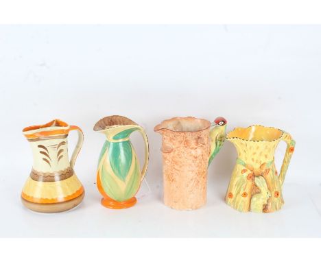 Four various pottery jugs, all in the Art Deco taste, to include a Weatherby example with Woodpecker handle, a Burleigh Ware 