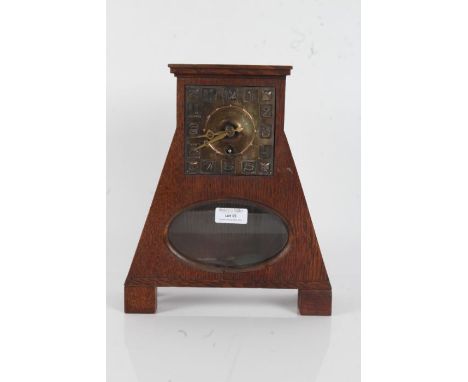 Arts and Crafts oak cased clock, the shaped case with square dial and arabic numerals, singe train movement, with glazed oval