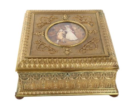 An ornate French gilt-metal casket, circa 1900, central hand painted ivorine panel depicting 2 lovers, in ornate relief cast 