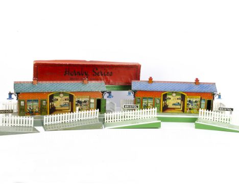 Two restored Hornby 0 Gauge Stations, comprising a grey-platform 'Windsor' with opening doors, G, lithography good, fences re