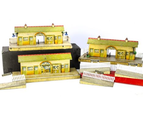 Three part-restored Hornby 0 Gauge 'speckled-platform' Stations, two no 2 stations with added light fittings, and pairs of ra
