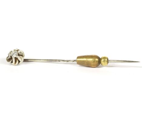 A single stone brilliant cut diamond stick pin, claw set to a stylised head