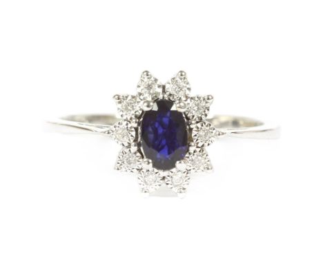 An 18ct white gold sapphire and diamond oval cluster ring, finger size P LE2.99g