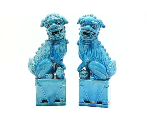 A pair of blue glazed Chinese ceramic temple dogs