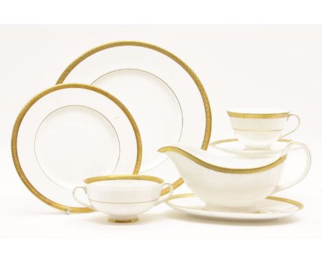 A Royal Doulton Royal Gold porcelain dinner service, consisting of twelve dinner plates, cups, saucers, side plates, etc