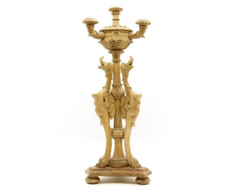 A Continental carved wooden three light candelabra, with winged grotesque supports, 60cm tall