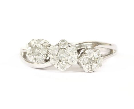 A 9ct white gold triple cluster diamond crossover ring, hallmark indistinct, finger size L½2.66g