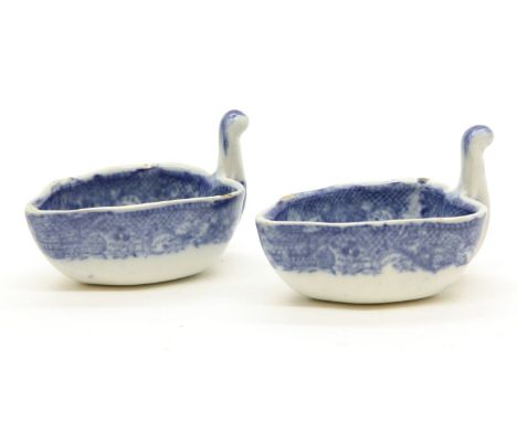 A pair of early 19th century blue and white transfer printed butter boats, possibly Spode, each with bullseye workmans mark t