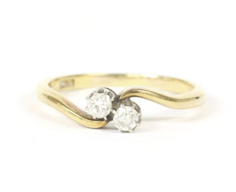 A gold two stone diamond crossover ring, marked 18ct, 3.08g