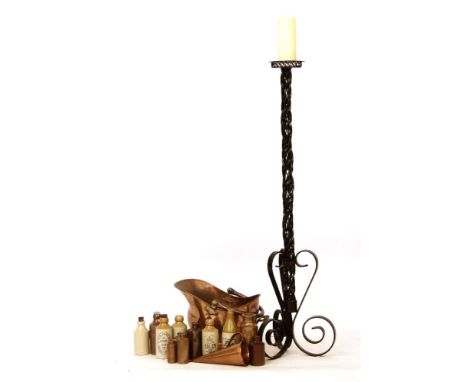 A large wrought iron pricket candle stick, together with a copper coal scuttle and a collection of stoneware bottles, etc