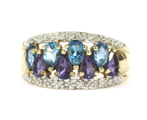 A gold four row pear cut purple and blue stone and diamond ring, tapering band ring possibly blue topaz and tanzanite, (teste