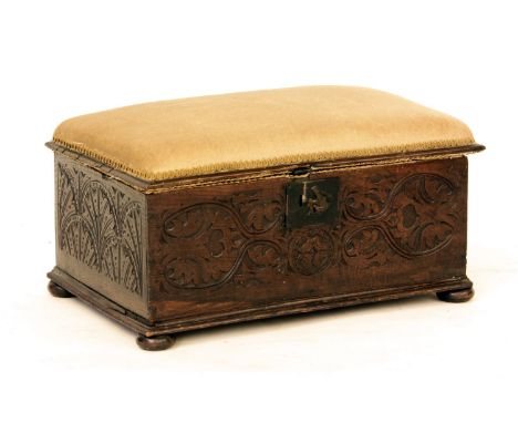 A carved oak ottoman with pad seat together with a carved oak stool with hinged top (2)