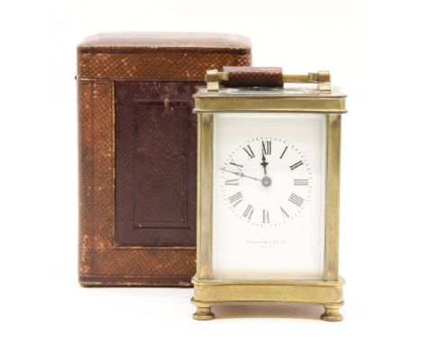 An early 20th century brass carriage clock, the white dial marked Elkington & Co. Paris and in glass cased and travelling box