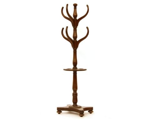 A mid 19th century mahogany hat and stick stand, with gadrooned moulding, and platform base, 160cm