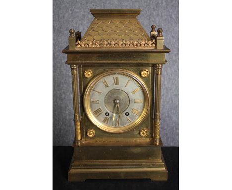 A 19th century brass architectural design mantle clock with tile detailing to the roof. Silvered dial with Roman numerals. H.